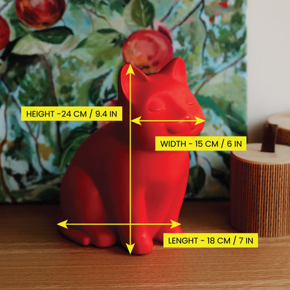 Red cat-shaped ceramic urn with measurements displayed on a wooden surface. Features personalized cat urn for ashes, custom cat cremation urn, cat-shaped urn, angel cat urn, sleeping cat statue urn, and pet urns for cats with engravable and personalized options.